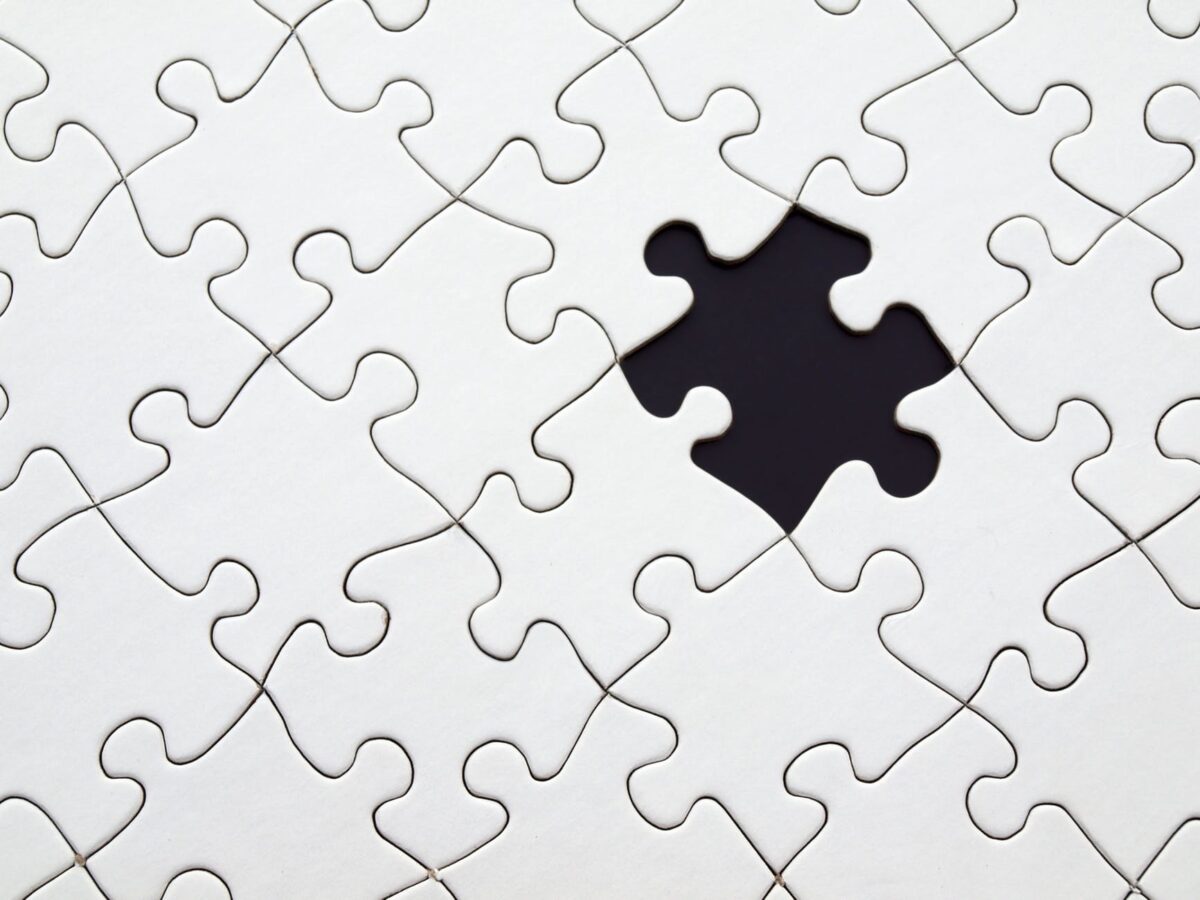 image of connected white puzzle pieces with one missing in the middle